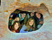 A YAWG group explores their surroundings, here at a cave in Petra, Jordan.