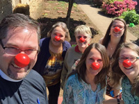 No, it's not some strange initiation ritual. It's intern Jamie Donahue (top right) having fun with the staff of Bethel Lutheran.