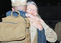 Petty Officer 3rd Class Colin Kroeker, corpsman, L Co., 3rd Battalion, 4th Marines, hugs his mother, Melissa, during a homecoming at Del Valle Field, Oct. 9, 2013.